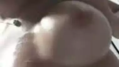 Beautiful girl massaging lovely boobs with lotion